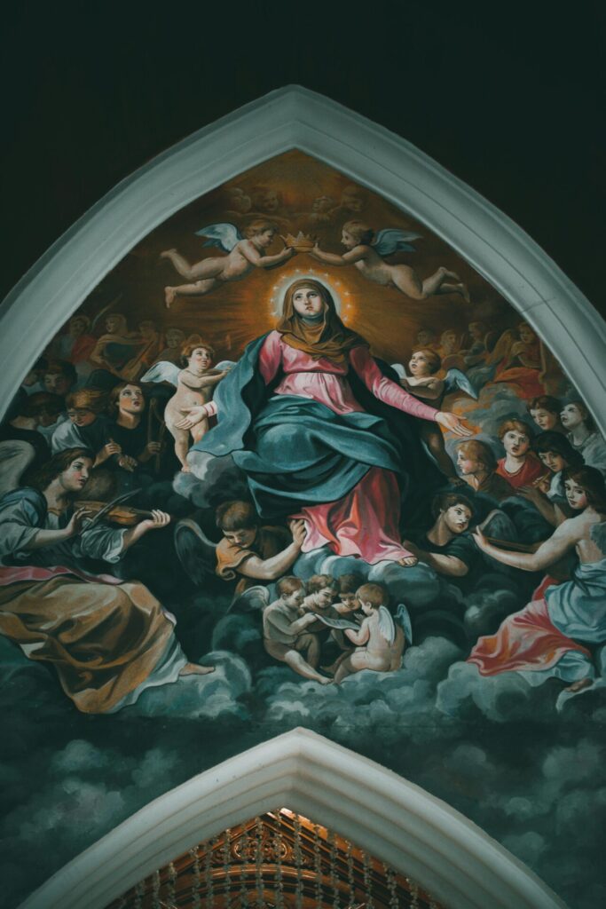 Stunning fresco depicting the Virgin Mary surrounded by angels in a cathedral setting.
