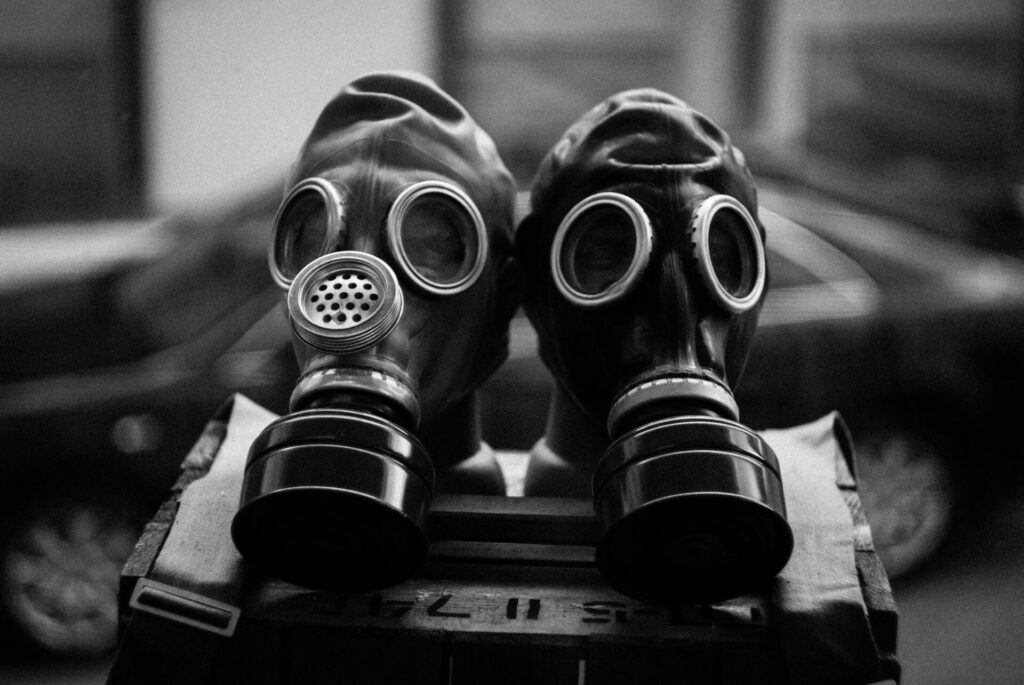 Close-up of two gas masks in black and white, emphasizing protection and preparedness.